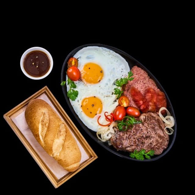 Bò Né / Beef Filet Mignon, Eggs, and Pate on Sizzling Plate.